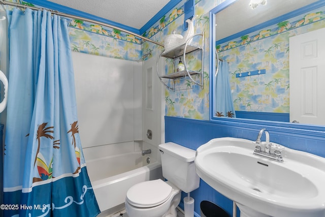 full bathroom featuring toilet, sink, a textured ceiling, and shower / bathtub combination with curtain