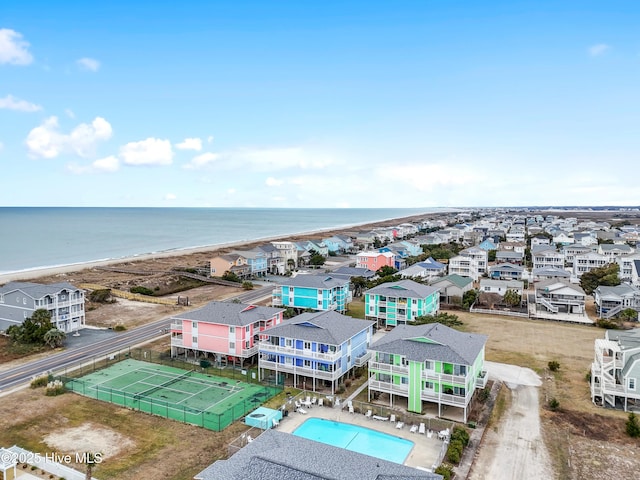 birds eye view of property with a water view and a beach view