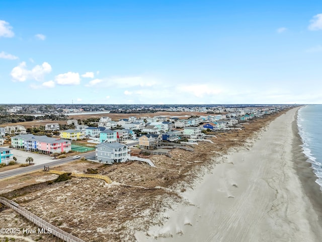 bird's eye view featuring a view of the beach and a water view