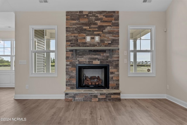 unfurnished living room with hardwood / wood-style flooring and a fireplace