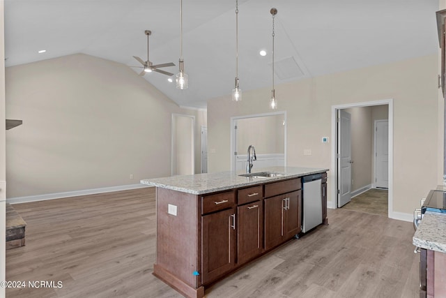 kitchen with sink, light stone counters, stainless steel dishwasher, an island with sink, and pendant lighting