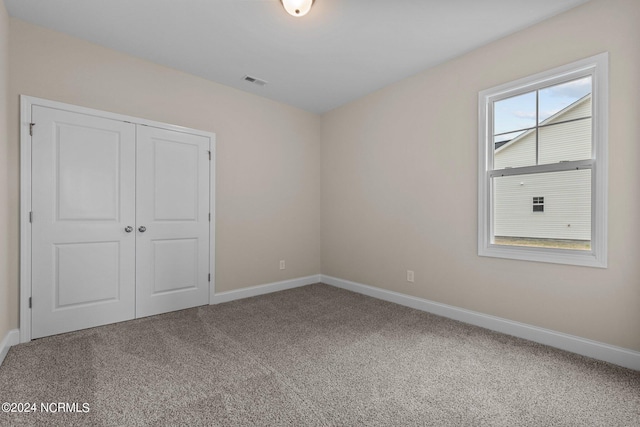 unfurnished bedroom featuring a closet and carpet