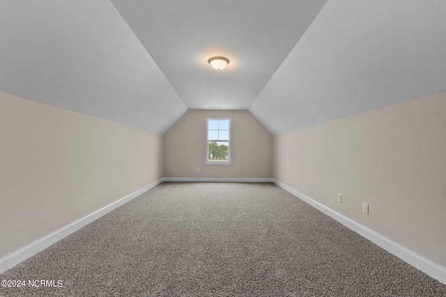 bonus room featuring lofted ceiling and carpet floors