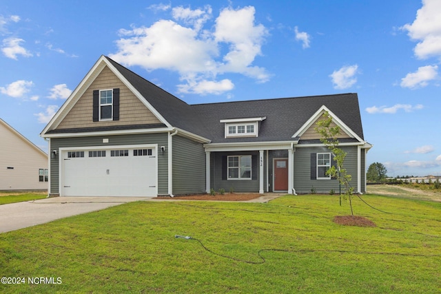 view of front of home with a garage and a front yard