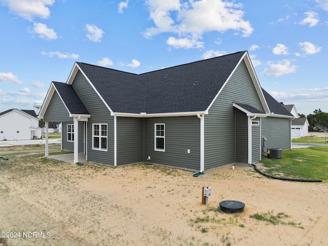 view of side of home featuring central AC unit and a patio