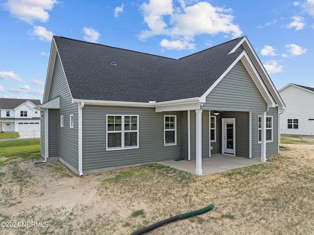 rear view of house with a lawn and a patio area