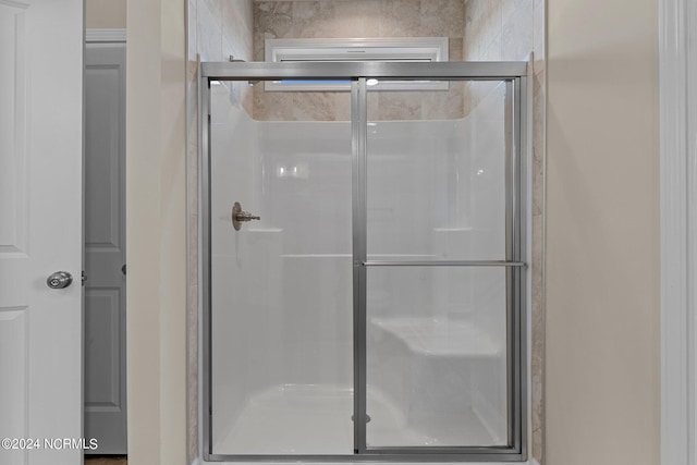 bathroom with a shower with shower door