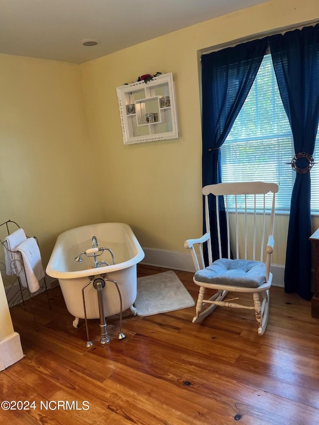 sitting room with wood finished floors and baseboards