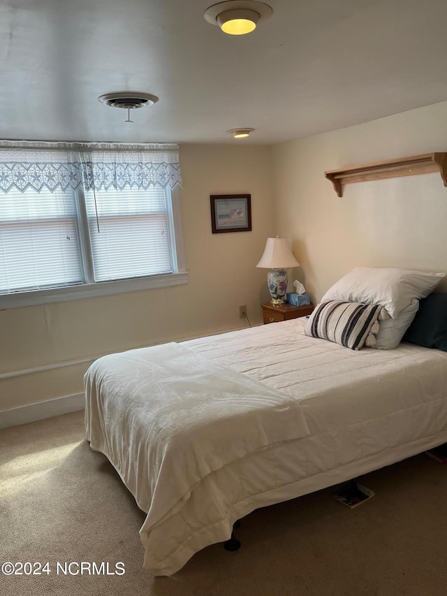 carpeted bedroom featuring visible vents