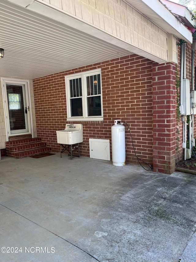 view of patio with a carport and entry steps