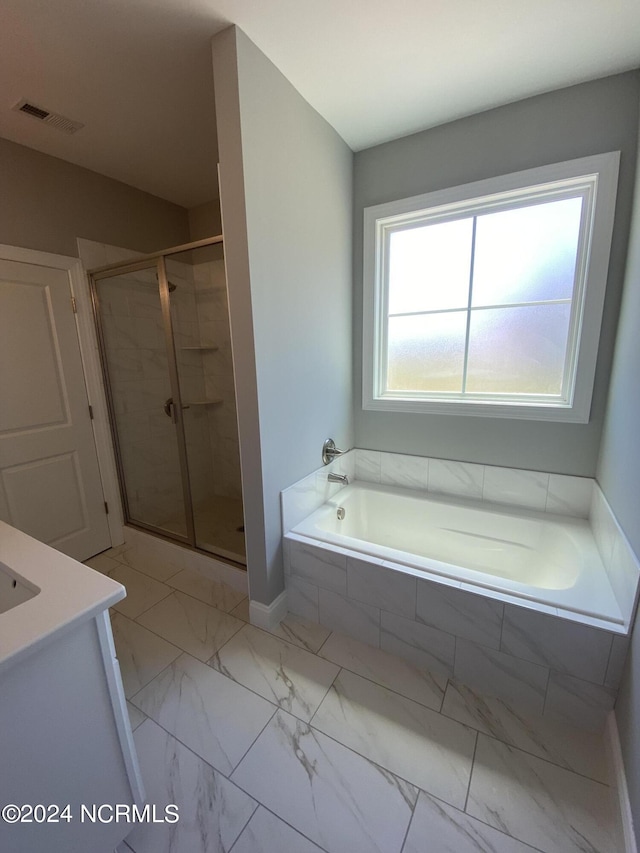 bathroom featuring plus walk in shower and vanity