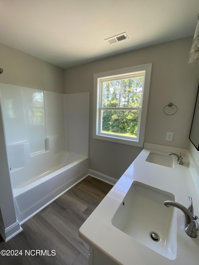 bathroom featuring vanity, shower / bath combination, and wood-type flooring