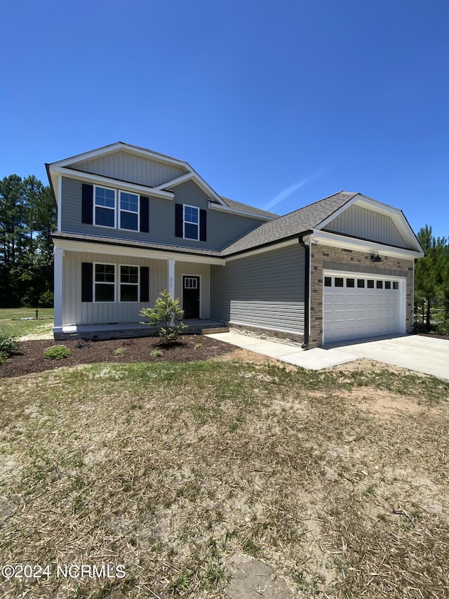 view of front facade with a front yard and a garage