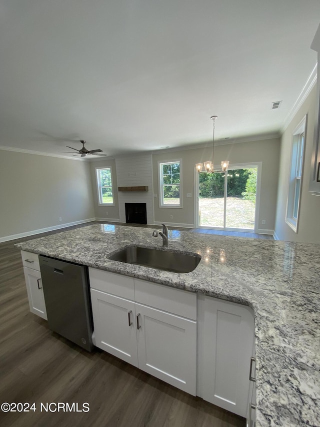 kitchen featuring ceiling fan with notable chandelier, white cabinetry, stainless steel dishwasher, and hanging light fixtures