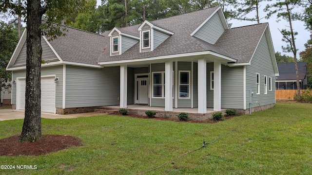 view of front facade with a front yard, a porch, and a garage