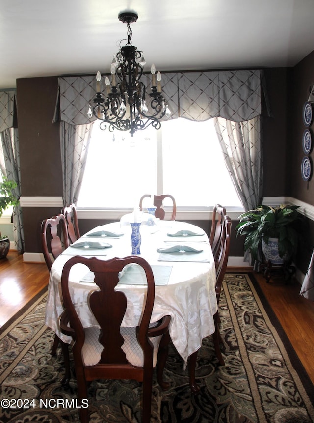 dining room featuring a wealth of natural light, an inviting chandelier, and wood-type flooring