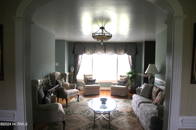 living room featuring hardwood / wood-style flooring and ornate columns