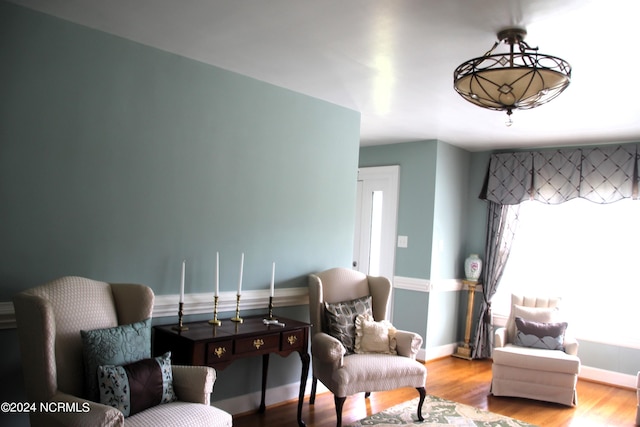 sitting room with wood-type flooring