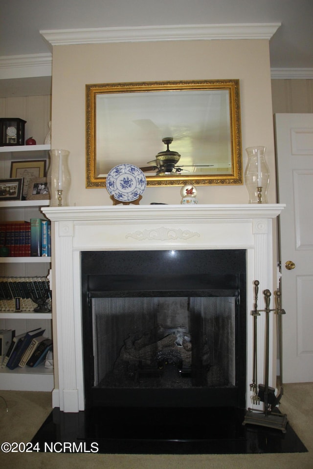 details with ornamental molding, carpet, and ceiling fan