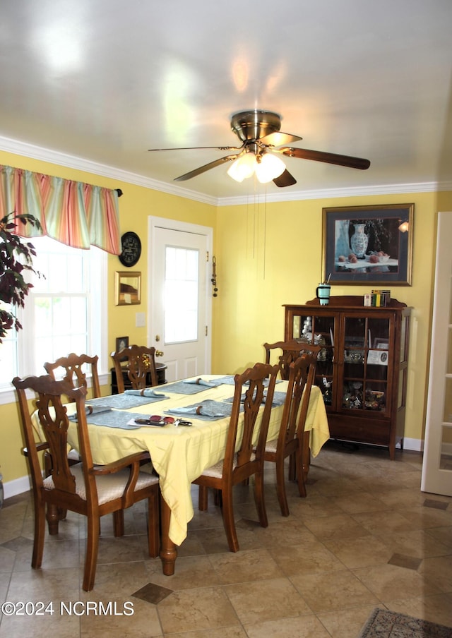 tiled dining space with plenty of natural light, crown molding, and ceiling fan