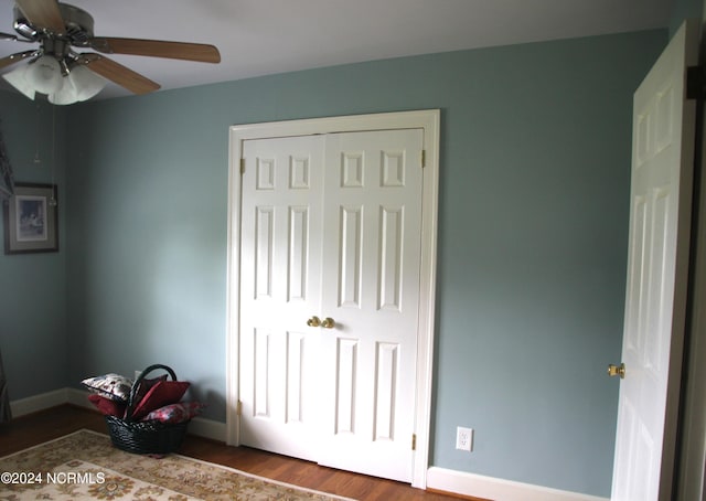 unfurnished bedroom with a closet, ceiling fan, and hardwood / wood-style floors