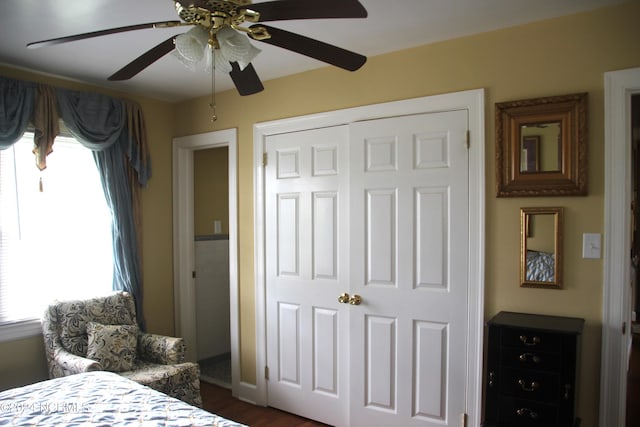 bedroom with a closet, ceiling fan, and dark hardwood / wood-style flooring