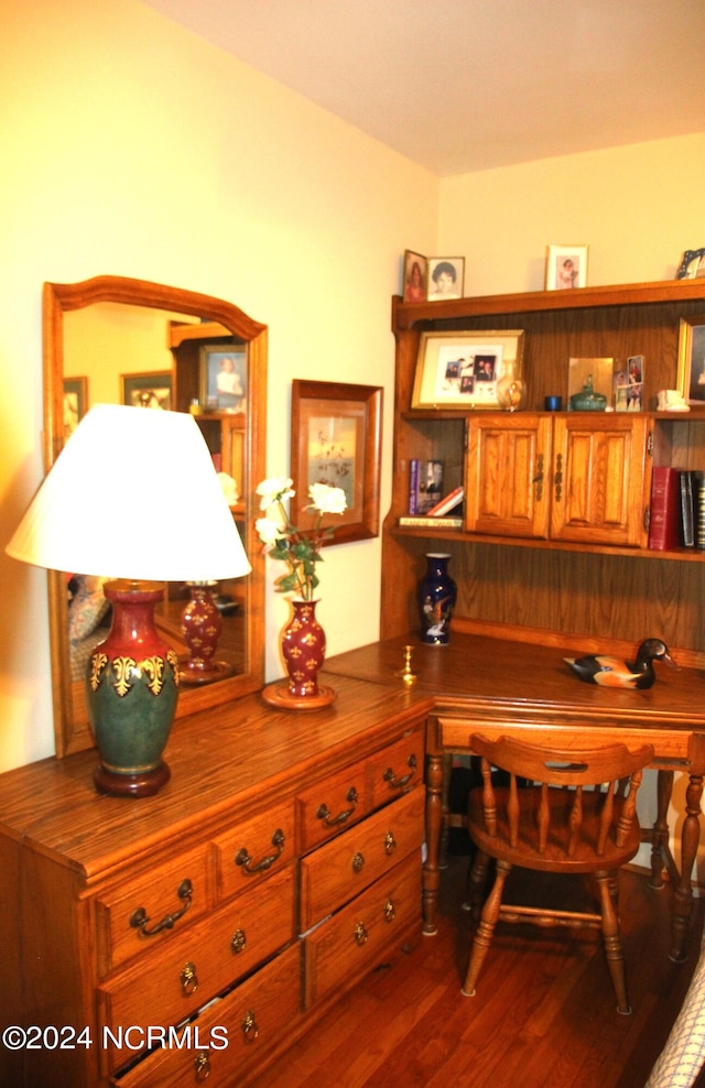 office with hardwood / wood-style floors and built in desk