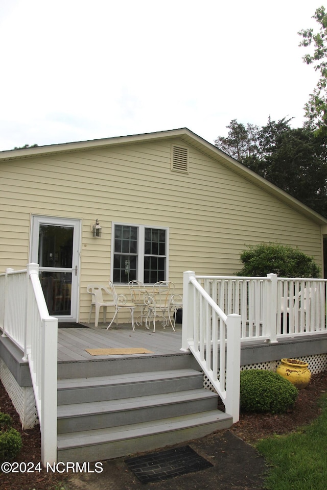 rear view of property featuring a deck