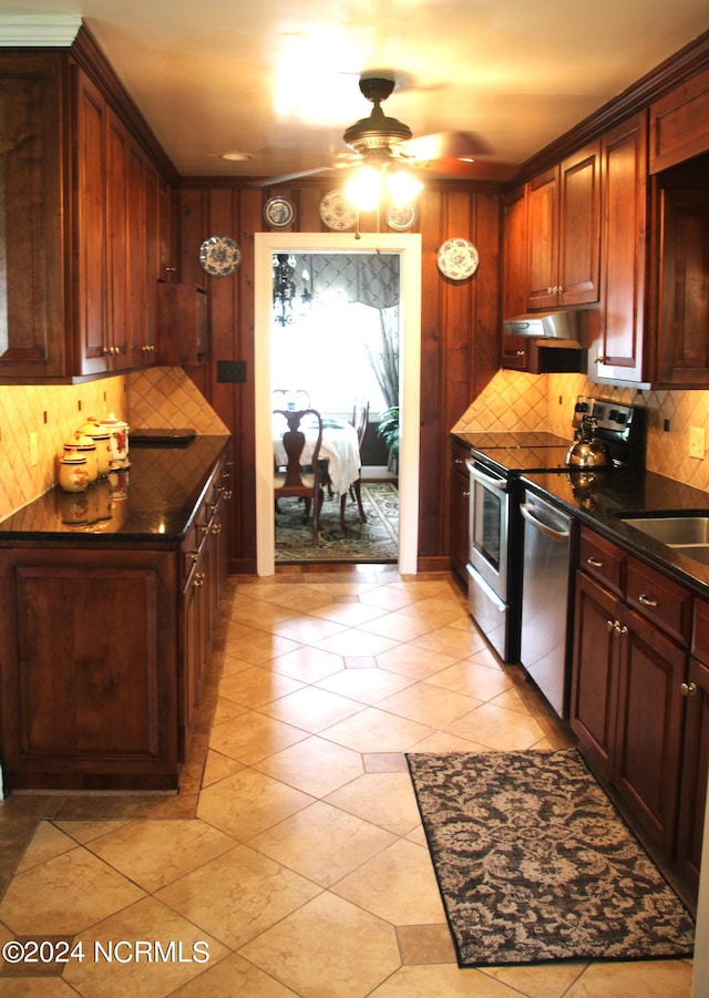 kitchen with ceiling fan, wall chimney exhaust hood, dishwasher, light tile flooring, and tasteful backsplash