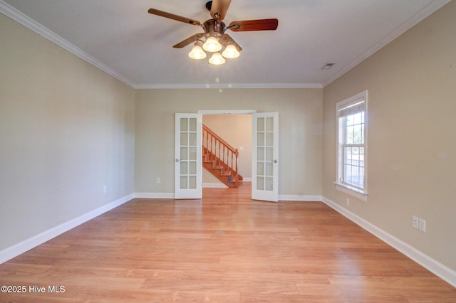 unfurnished room with light wood-style floors, french doors, ornamental molding, and baseboards