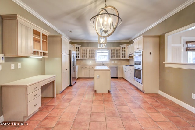 kitchen with decorative light fixtures, stainless steel appliances, a kitchen island, built in desk, and glass insert cabinets