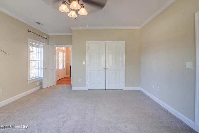 unfurnished bedroom with ornamental molding, light colored carpet, a closet, and visible vents