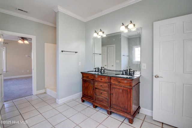 bathroom featuring double vanity, visible vents, ornamental molding, a sink, and tile patterned floors