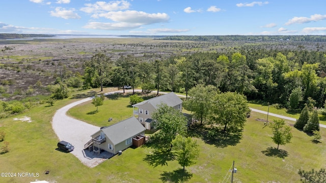 birds eye view of property featuring a view of trees