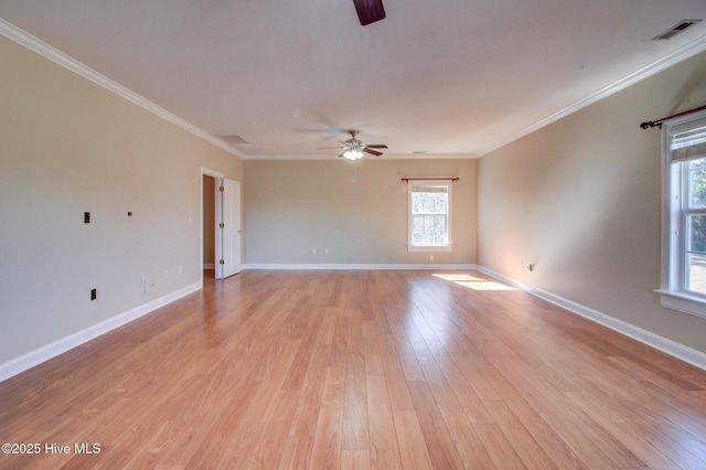 unfurnished room with ornamental molding, visible vents, light wood-style flooring, and baseboards