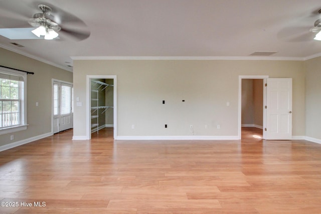 empty room with ceiling fan, crown molding, baseboards, and light wood-style floors