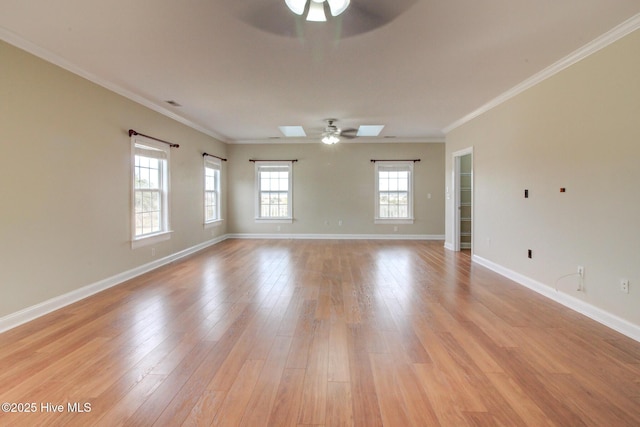 135 Vashti Dr, Morehead City, NC 28557 - empty room with a skylight, light wood-style floors, a ceiling fan, and baseboards