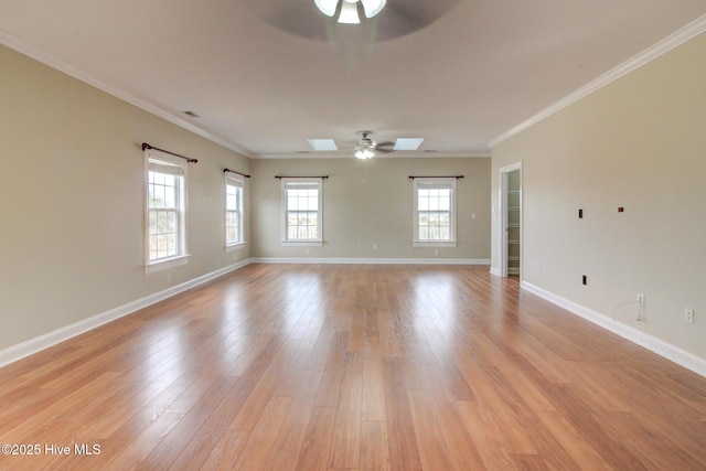 empty room with a ceiling fan, light wood-type flooring, ornamental molding, and baseboards