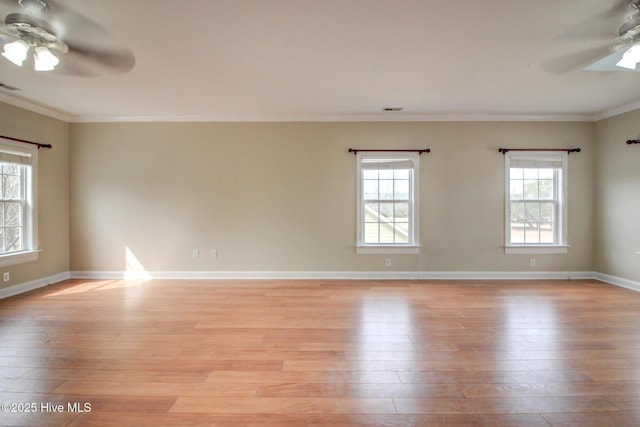 unfurnished room with a ceiling fan, baseboards, ornamental molding, and light wood finished floors