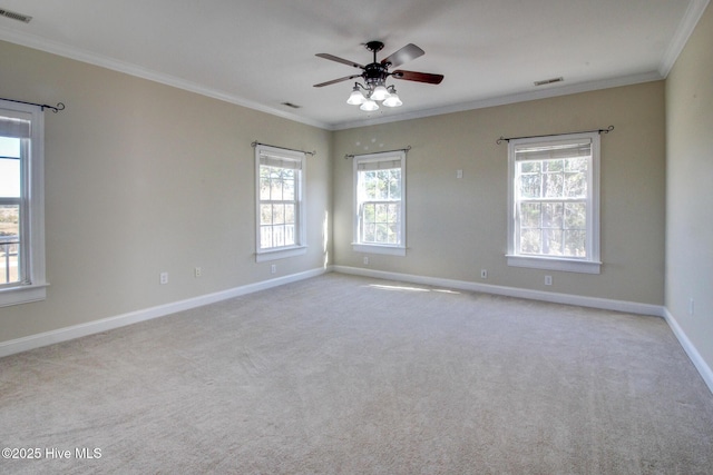 unfurnished room featuring visible vents, crown molding, and baseboards