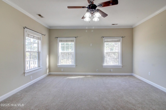 spare room with ornamental molding, visible vents, and plenty of natural light