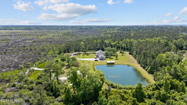 drone / aerial view with a water view and a wooded view