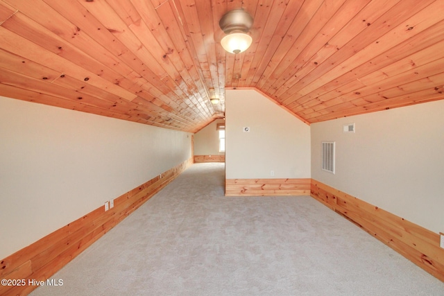 additional living space with carpet floors, lofted ceiling, wood ceiling, and visible vents