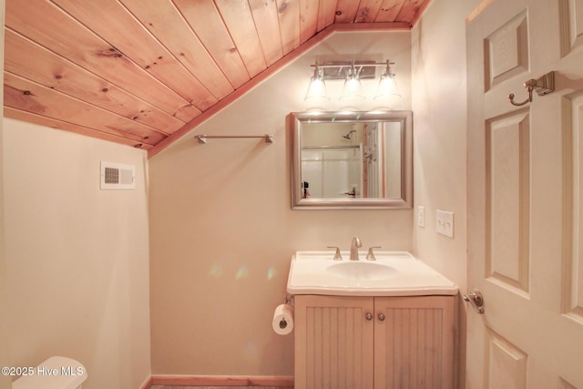 bathroom with visible vents, vaulted ceiling, vanity, and wood ceiling