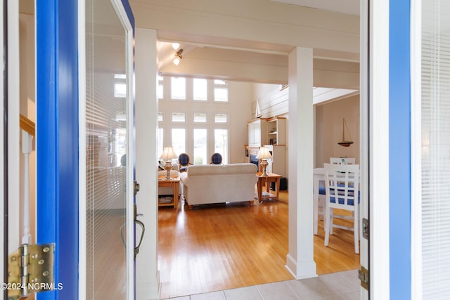 entrance foyer with lofted ceiling with beams and wood finished floors