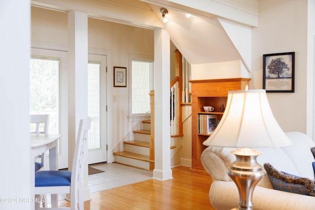 stairs featuring wood finished floors