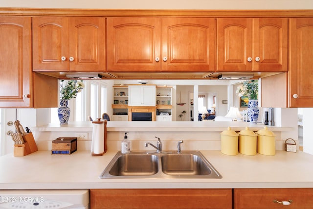 kitchen featuring brown cabinets, light countertops, and a sink