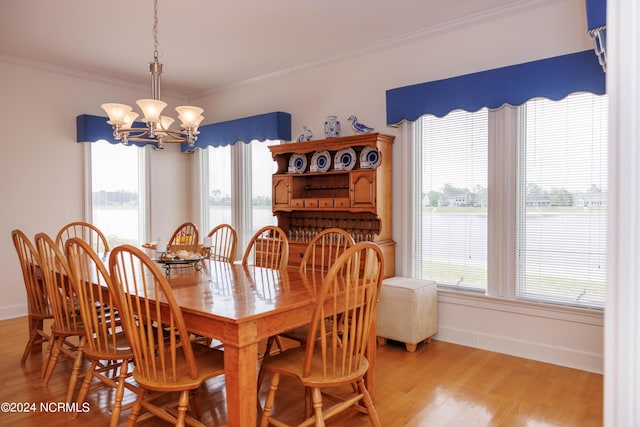 dining space featuring plenty of natural light, crown molding, and wood finished floors