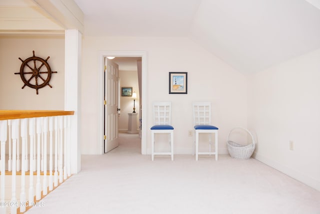 bonus room with lofted ceiling, light carpet, and baseboards