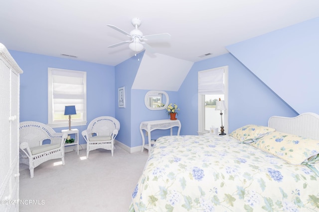 bedroom featuring lofted ceiling, carpet floors, visible vents, baseboards, and a ceiling fan